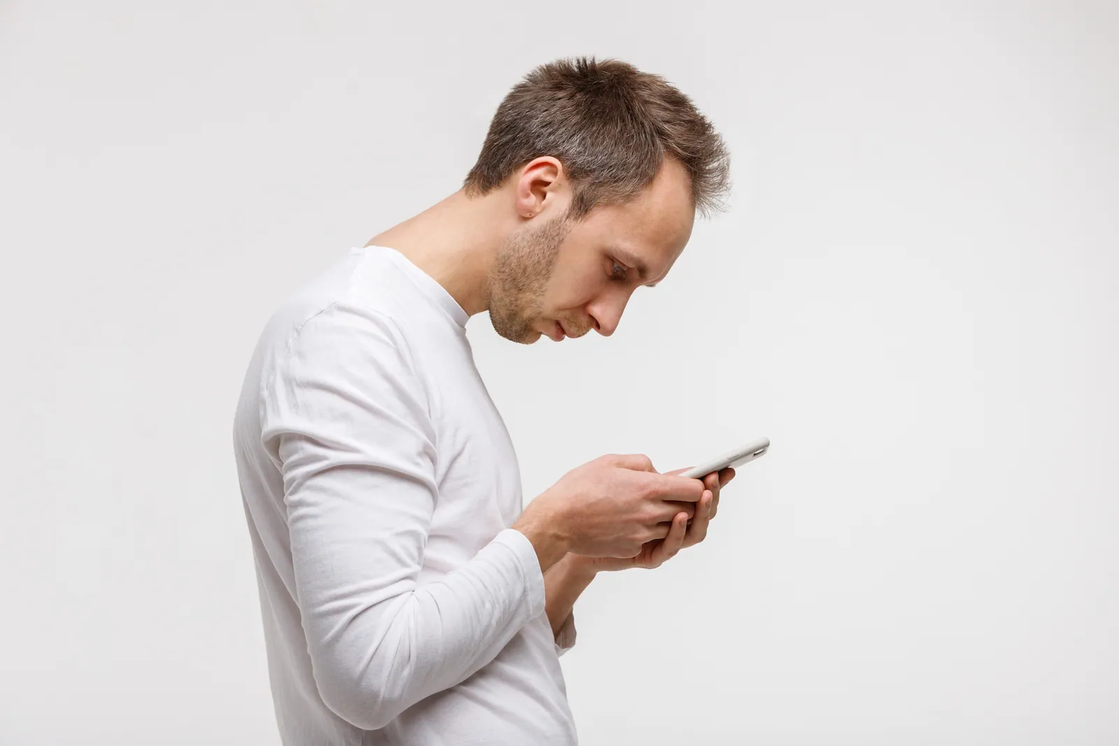 Man hunched over his phone