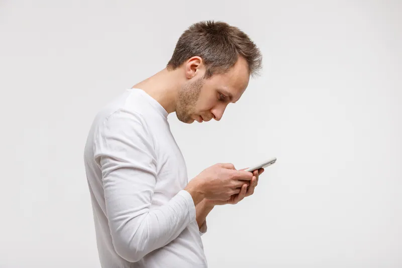 Man hunched over his phone