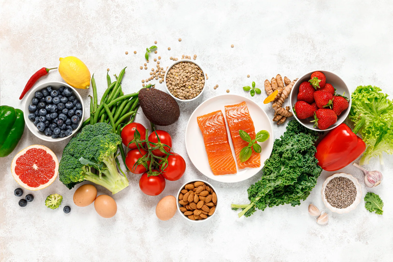 Healthy whole foods including salmon, vegetables and fruit