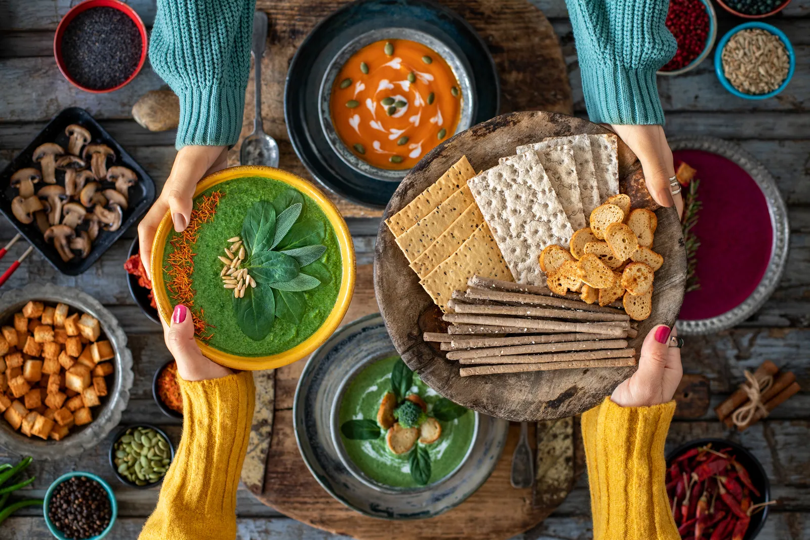 Hands sharing a table of healthy winter foods