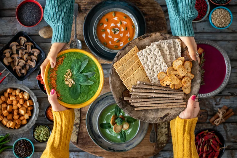 Hands sharing a table of healthy winter foods
