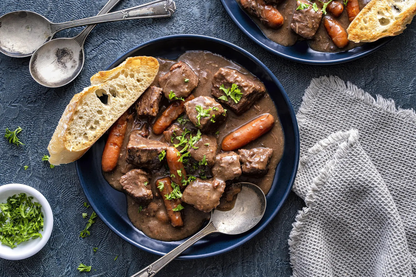 Bowls of beef stew with bread