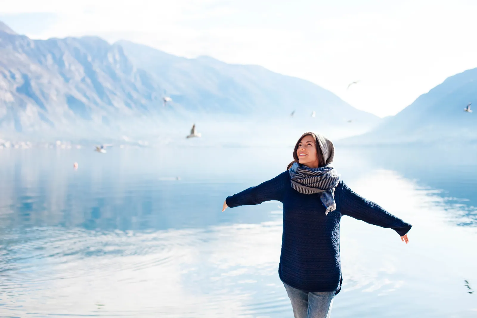 Woman enjoying a winter day by a lake